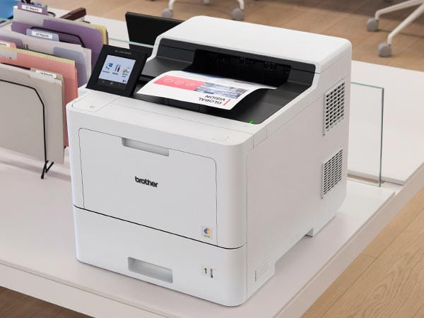 Printer on desk on corporate office, with company's global charter in output tray