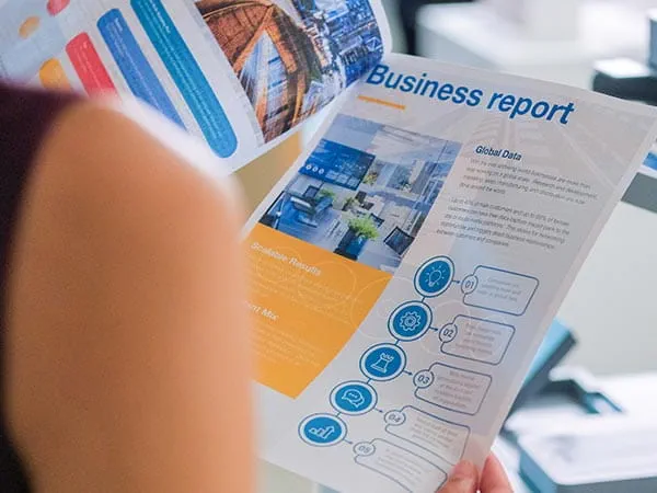 Woman reviewing full color printed business report
