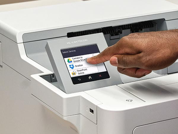 Person using printer's touchscreen to select print-from location: Google Drive, Dropbox, or Sharepoint