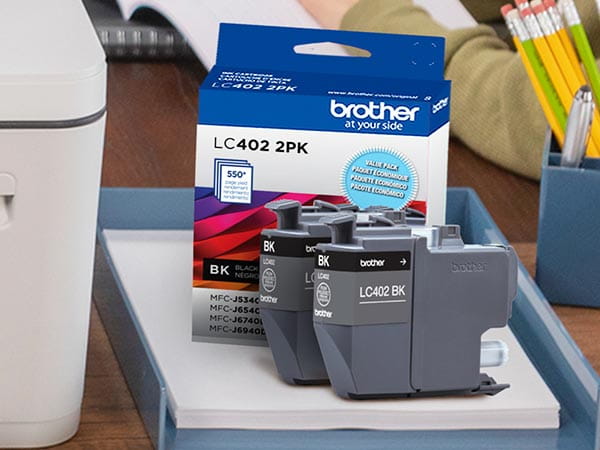 Replacement ink cartridge on desk next to printer