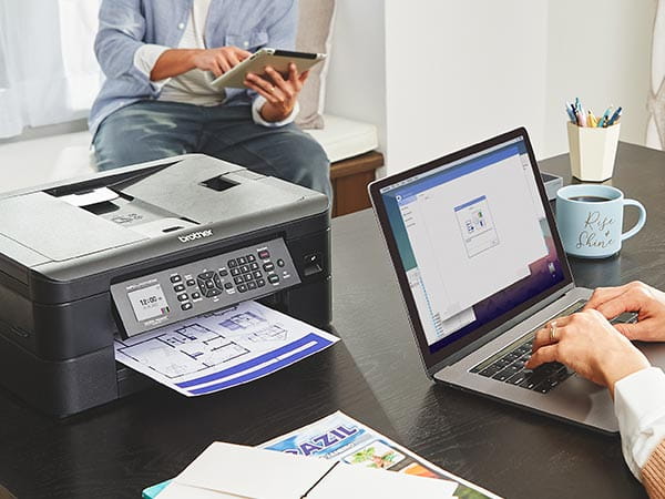 People printing documents from laptop and tablet