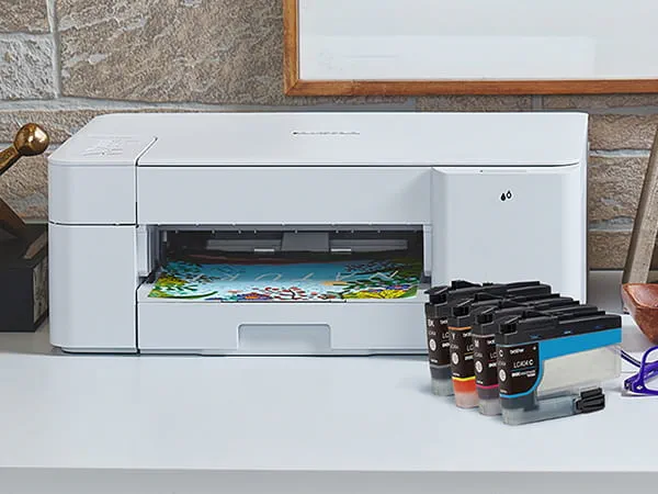 Printer on home counter with replacement ink cartridges