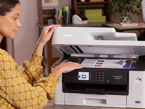 Woman placing document on printer's scan glass