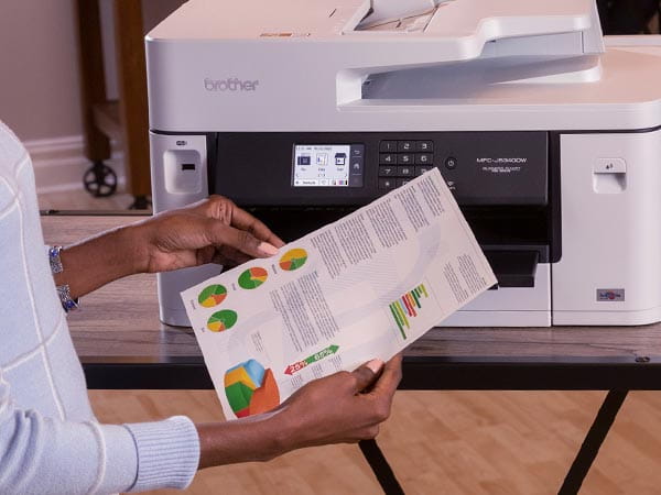 Woman reviewing double-sided full color printout