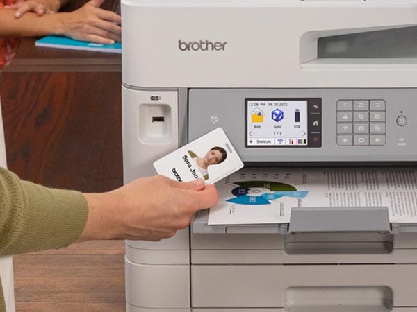 Woman using NFC badge to release print job from shared printer