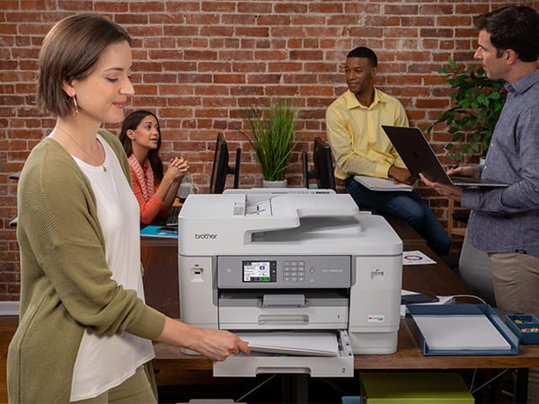 Woman in small office reviewing printed document
