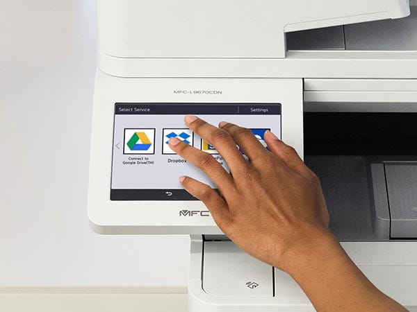 Person using printer's touchscreen to select print-from/scan-to location: Google Drive, Dropbox, SharePoint, or OneDrive