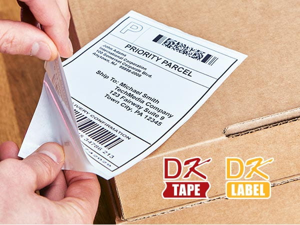 Person applying shipping label to box, with DK Label and DK Tape logos