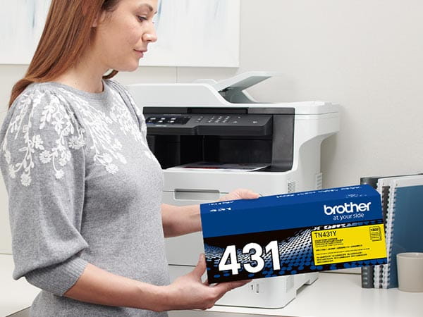 Person installing new toner cartridge into Brother laser printer