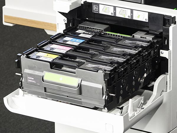 Printer with front panel open to replace toner cartridges