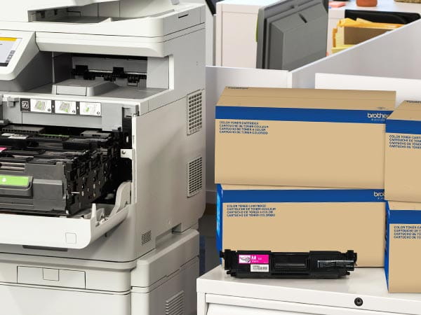 Laser printer in corporate office with boxes of replacement toner