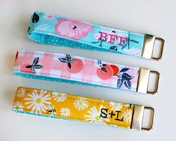 3 brightly colored keyfobs with embroidery.