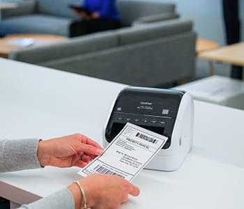 QL-1110NWB printing label on a desk