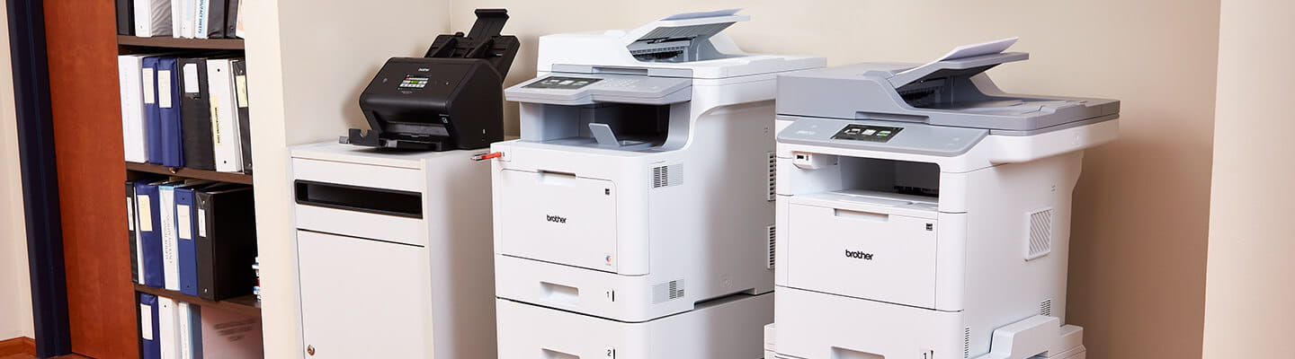 ADS-3600, MFC-L9570CDW and MFC-L6900DW printers in an alcove. 