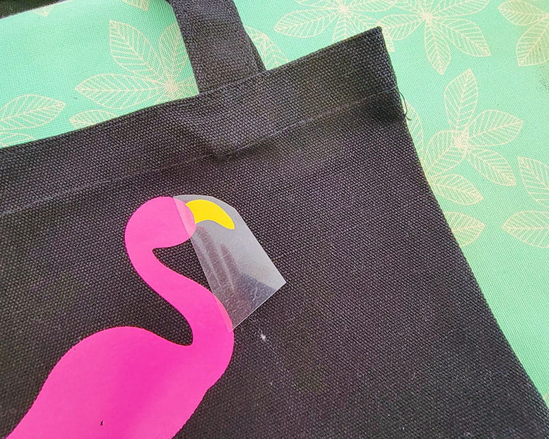 Beak attached to flamingo on black tote