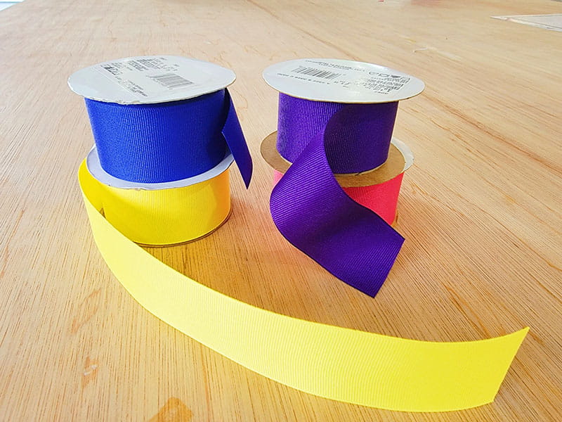 Spools of ribbon in yellow, blue, purple and pink