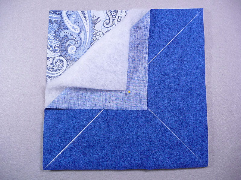 3 Fabrics laying on top of each other in square pattern, on the bottom is fabric1, middle is felt, and top is fabric2