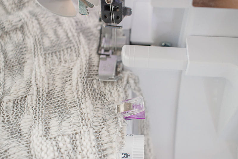 Putting the sweater knit through the sewing machine
