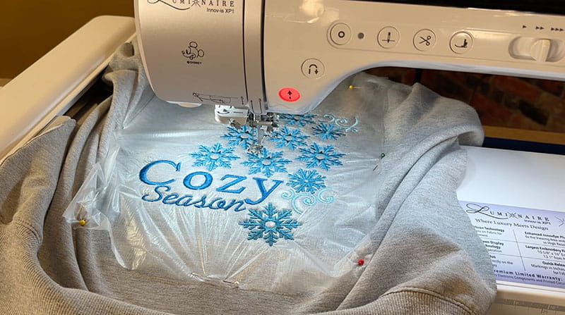 Grey cozy sweatshirt with blue flower embroidery