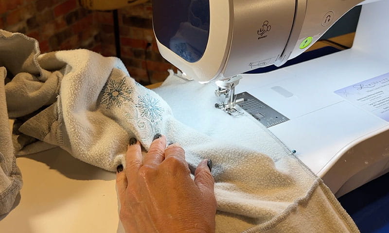 Embroidery machine stitching on grey sweatshirt