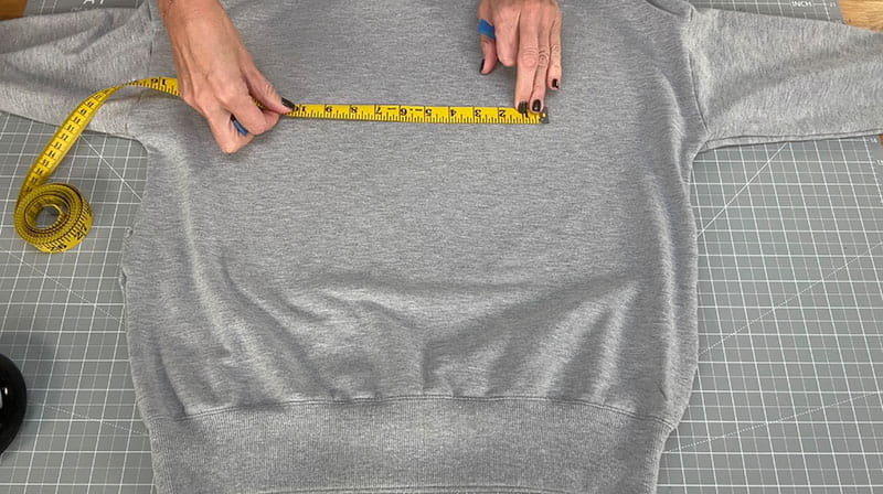 Measuring tape on grey sweatshirt