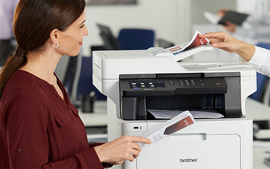 Woman holding printout from Brother printer