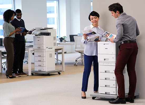 People in office using HL-L9470 laser printer and MFC-L9670 all-in-one business printer.