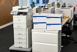 Brother MFC-L9670 printer in an office next to TN810XL toner.