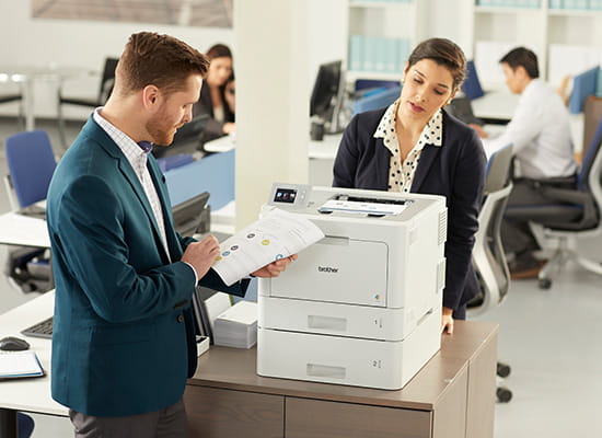 Employees printing documents on a Brother HL-L9310CDW printer