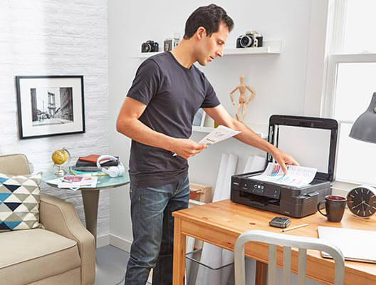 Man Using Scanner in Home Office