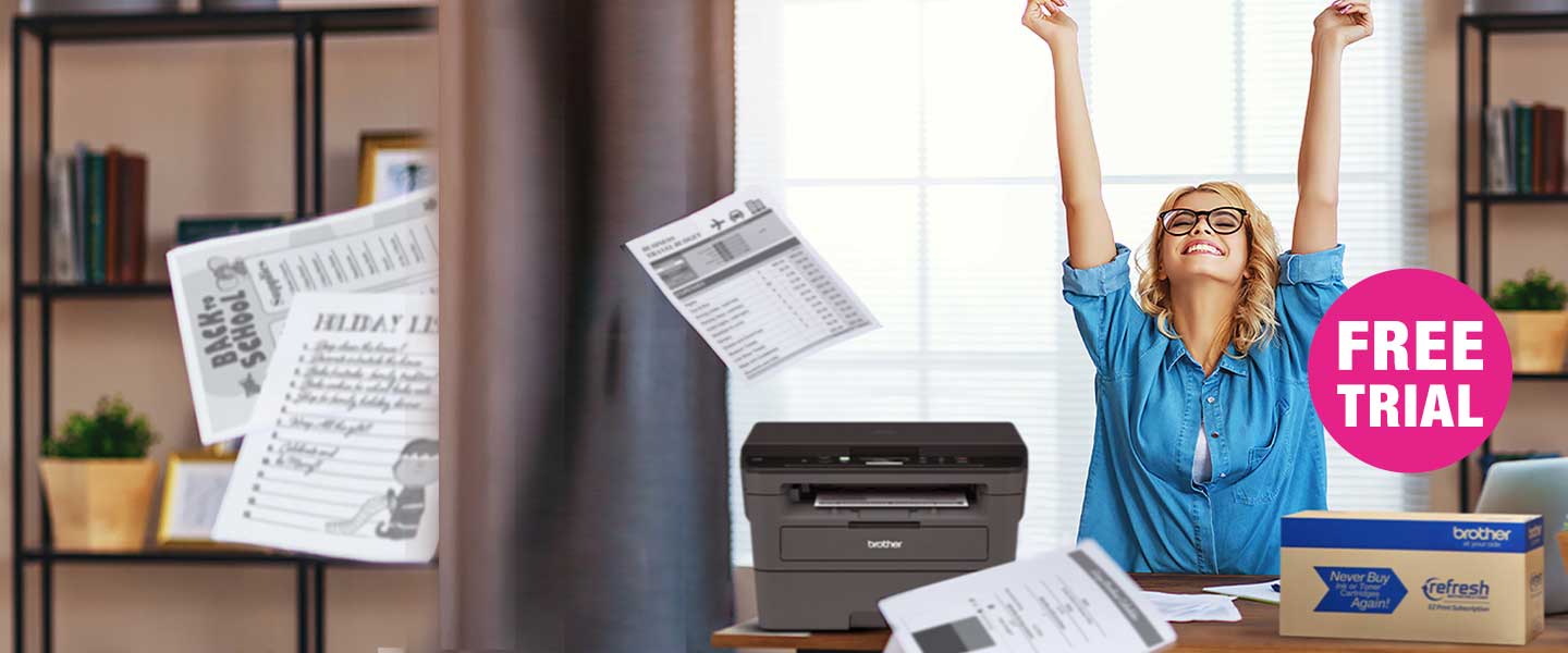Woman celebrating throwing papers in the air and smiling as a Refresh carton sits on her desk