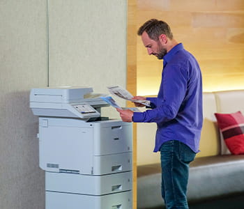 Man using Brother MFC-L9670CDN enterprise laser printer in an office