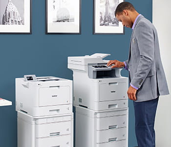 Man printing on a Brother Workhorse fully configured color laser printer for medium business.