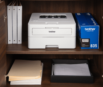 Brother Printer with Ink box next to it on a cabinet