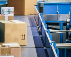 Boxes on blue conveyor belt that uses Brother gearmotors