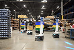 Locus robots made with Brother gearmotors in warehouse setting