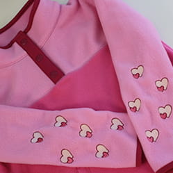 Pink pull over with hearts embroidered on both sleeves