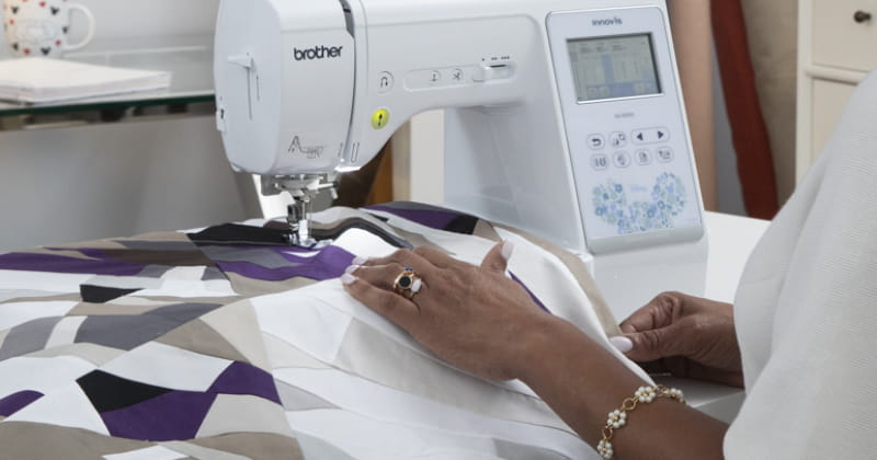 Woman feeding fabric through NS1850D