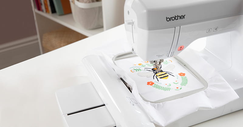 NS1250E with bee embroidery design in hoop