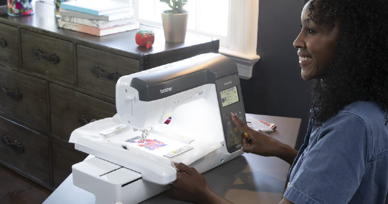 NS28%0D with woman adding hoop to the machine