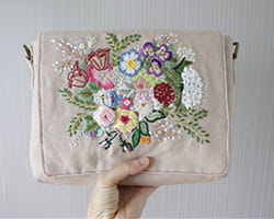 Flower embroidery on a makeup bag