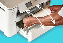 Person feeding fabring into tray of PrintModa fabric printer