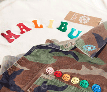 Shirt with embroidered "Malibu" text and camo jacket