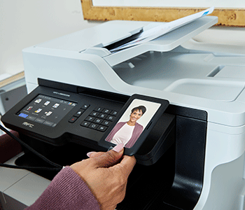 Woman scanning ID badge at printer