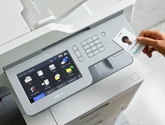 Employee badge being scanned at printer