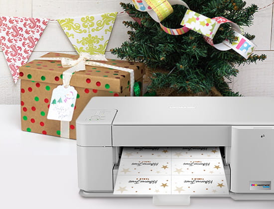 Brother printer next to wrapped gifts, under a tree