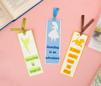 3 Disney bookmarks made with ScanNCut on a pink background
