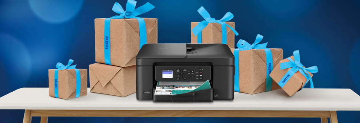 Brother printer on a table surrounded by presents in brown wrapping with a blue bow against a blue background.