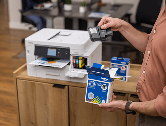 Person changing an ink cartridge in a printer. 