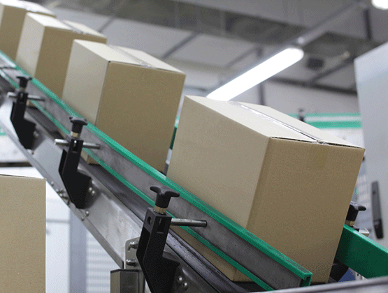 Brown boxes on conveyor belt going up